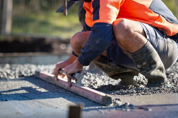 Pouring and leveling a new concrete slab for a residential house under construction in Melbourne Australia